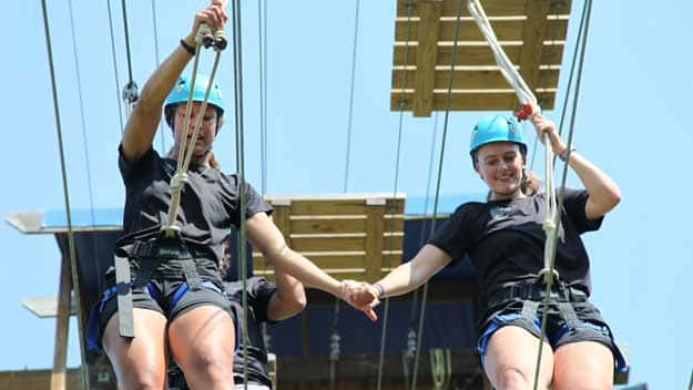 CSL students tackle the ropes course at Signature Team Building.