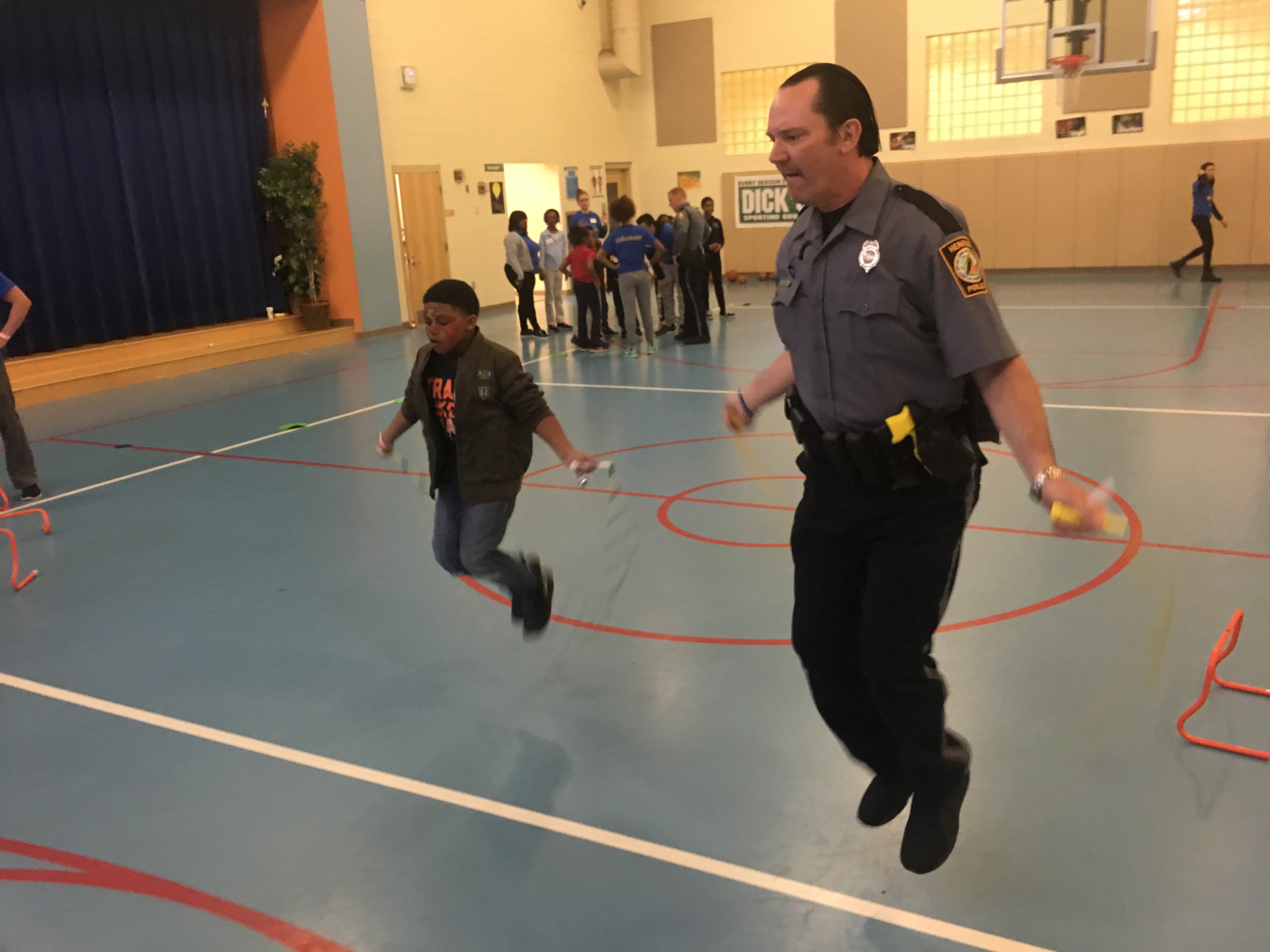 police officer jumping rope with a kid